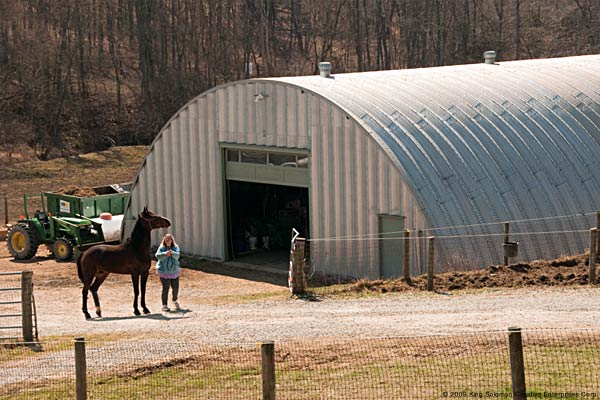 Large q-model steel building used to keep and care for multiple horses.