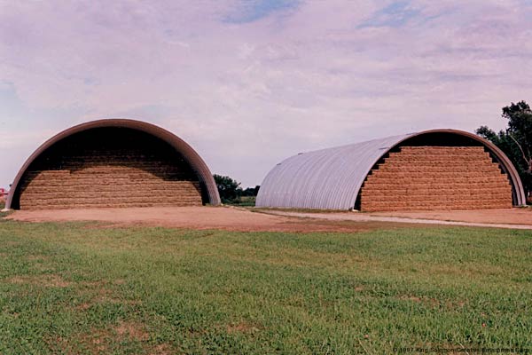 A pair of large q-model hay storage buildings